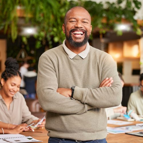 Black man, portrait smile and arms crossed in leadership for meeting, teamwork or brainstorming at